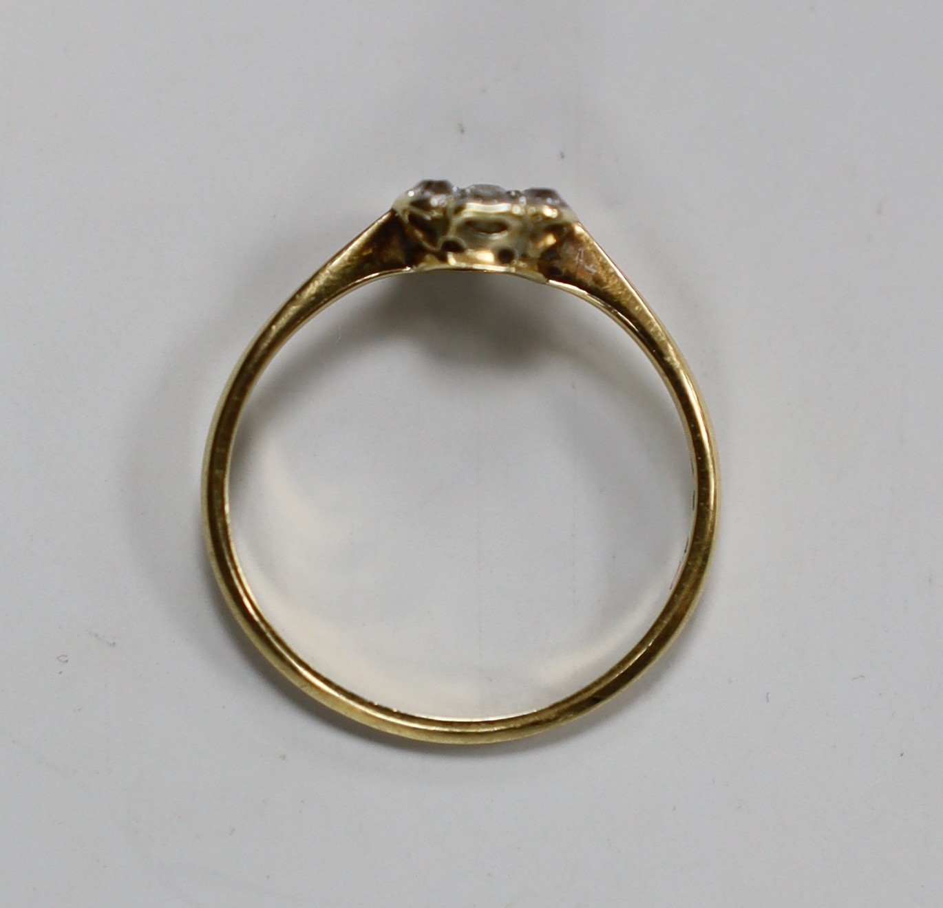 An 18ct and diamond cluster ring, size L/M, gross weight 1.4 grams.